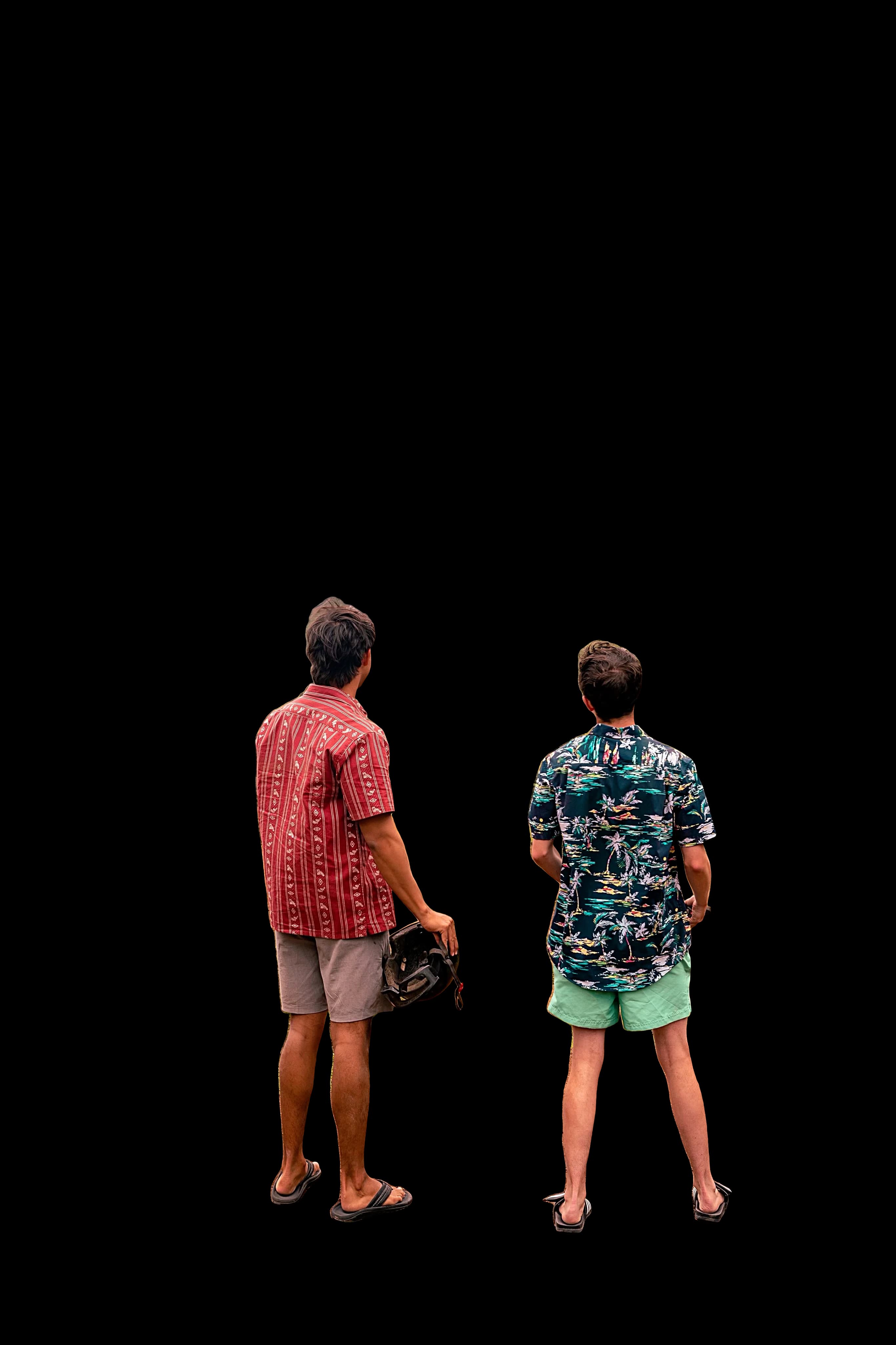 Two people looking up at the ridged green cliffs at Kualoa on Oʻahu. The person on the right is a BurntBase co-owner.